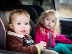 cute small children in car seats in the car