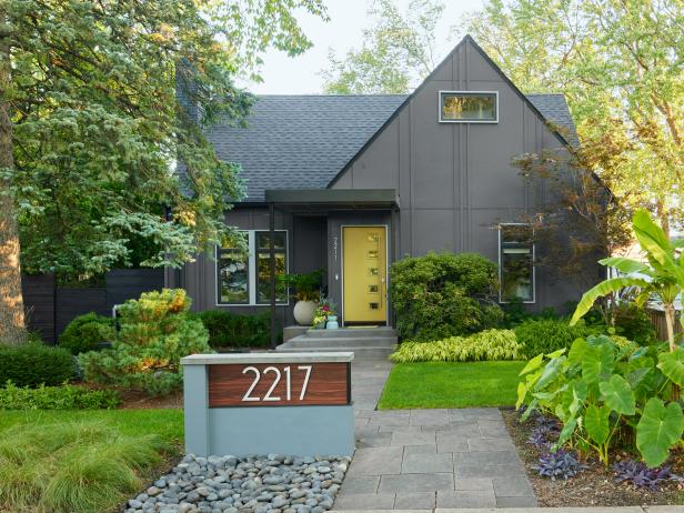 Gray Board and Batten House With Yellow Midcentury Modern Door