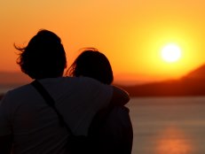 Couple Admiring View From Temple of Poseidon at Cape Sounion, Greece