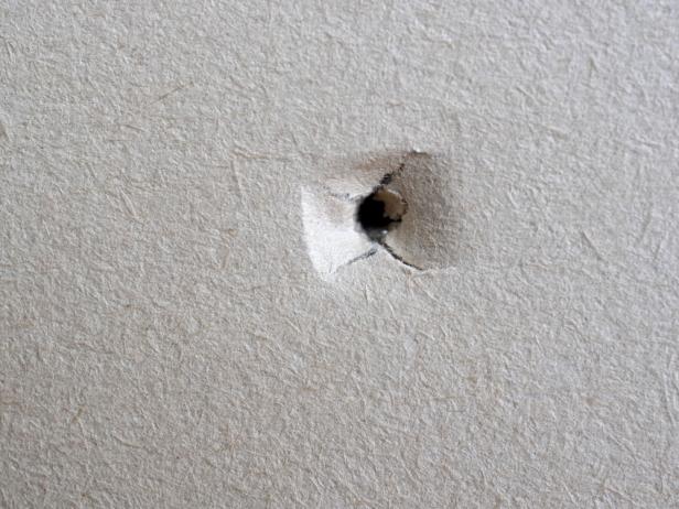 View of hole in the beige plasterboard