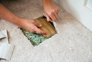 Press the new patch into the hole in the carpet.
