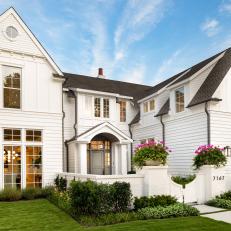 White Home Exterior With Gated Entry