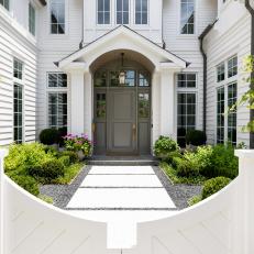 Traditional White Home With Arch Over Front Door