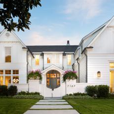 Traditional White Home With Walkway Leading to Front Door