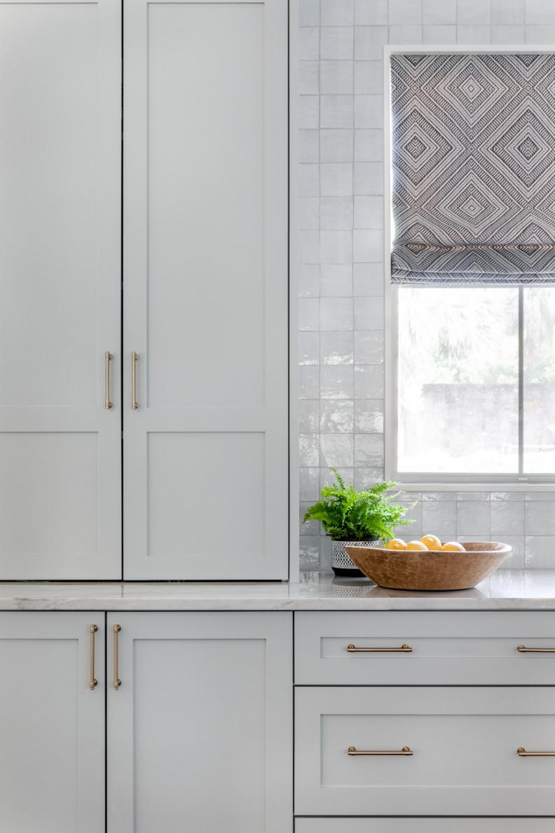 Transitional Kitchen With Gray Tones and Patterned Curtain
