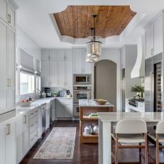 Gray Kitchen Warmed With a Wooden Island and Accent Ceiling