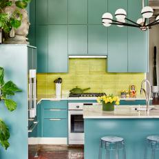 Loft Kitchen is Bright With Blue Cabinets and Green Backsplash