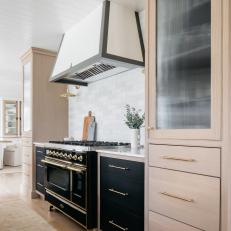 Stunning Kitchen With White Oak Cabinets, Vintage Rug and Plaster and Metal Range Hood
