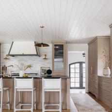 White Oak Kitchen With Gold Hardware and White Barstools