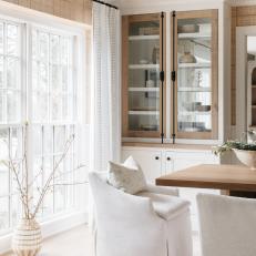 Dining Room With Large Window and Glass Built-In Cabinet