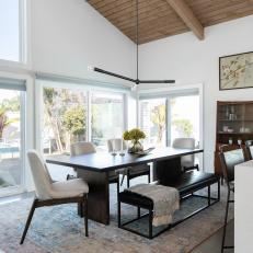 Midcentury Modern Dining Room With Black Accents and Large Windows