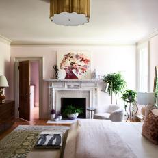 Blush Victorian Bedroom With White Fireplace