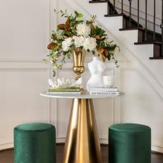 Entryway Greets With Gold + Marble Table and Green Velvet Stools