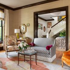 Living Space With Mixed Patterns and Rich Chocolate Wall Trim