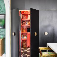 Black Cabinetry With Hidden Red Pantry