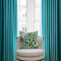 Bold, Blue Curtains and Decorative Pillow in Sitting Room