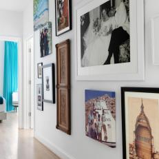 Hallway Leading to Bedroom Featuring Artwork and Photographs