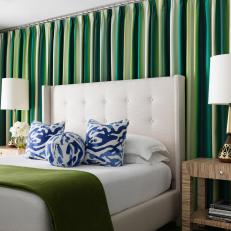 Bedroom With Green Curtains and Blue Pillows