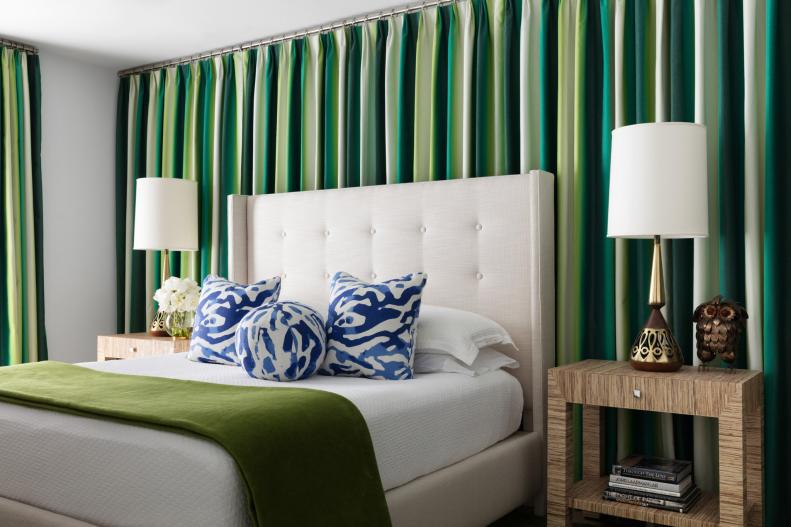 Coastal Bedroom With Green Curtains and Blue Pillows