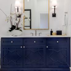 Blue and White Bathroom With Brass Mirror