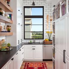 Black and White Butler's Pantry With Red Rug