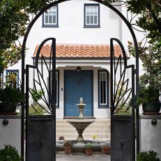 Mediterranean-Style Courtyard With Ornate Gate and Fountain
