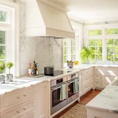 White Transitional Chef Kitchen With Marble Wall