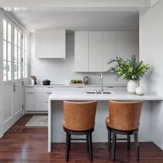 White Modern Kitchen With Leather Stools