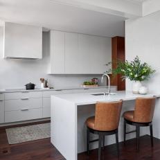 White Modern Kitchen With Leather Barstools