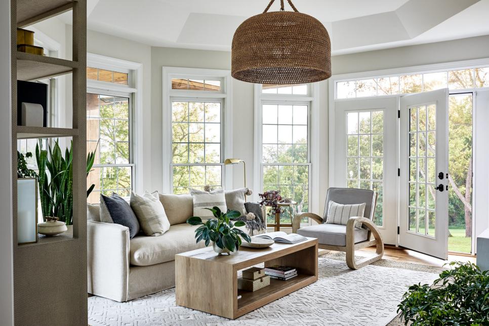 Tray Ceiling Sunroom With Big Windows, Neutral Sofa and Coffee Table