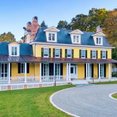 Historic Yellow Farmhouse With Expansive Porch and Stone Driveway Sculpture