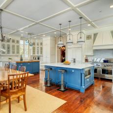 Blue and White Farmhouse Kitchen With Gleaming Hardwood Floors