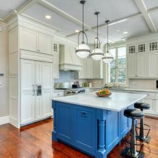 White Farmhouse Kitchen With Seated Blue Island and Pendant Lights