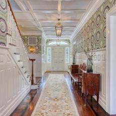 Historic White Farmhouse Foyer With Patterned Wallpaper and Antique Bench