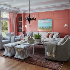 Bright Pink Living Room With a Black Chandelier and Upholstered Furniture