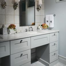 Double Vanity Bathroom Features White Textured Tile and Silver Wall Scones