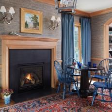 This Classic Living Space Features a Fireplace and a Small Round Table