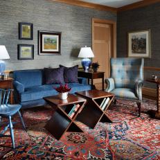 Cozy Living Room Features an Antique Rug and a Blue Velvet Sofa
