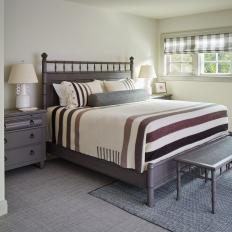 Neutral Bedroom Features a Matching Bedroom Suite and a Small Bench