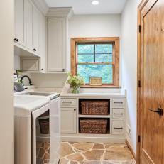 Rustic, White Cottage-Style Laundry Room With Stone Floors 