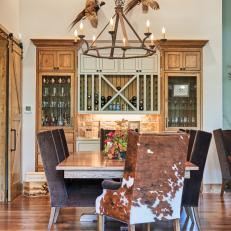 Rustic, Brown and White Dining Room With Cowhide and Taxidermy