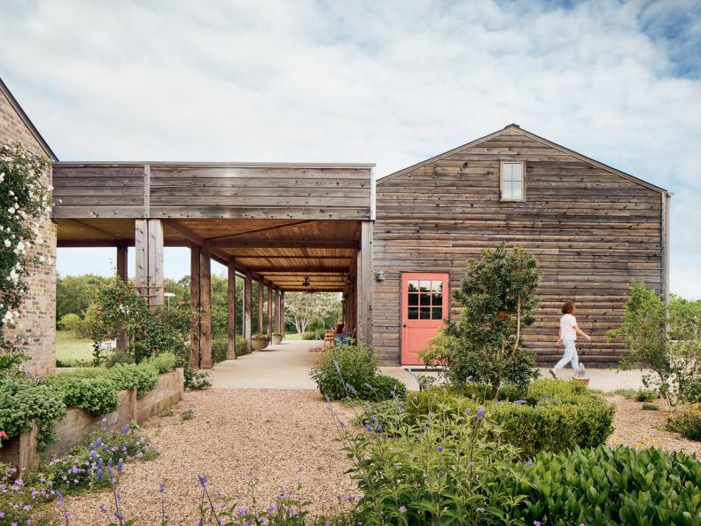 A Rustic Building With Cedar Siding and a Pink Door