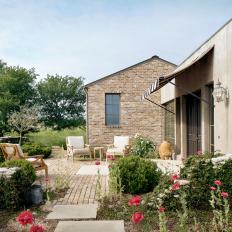 A Stone Patio Surrounded by Garden Beds Creates the Perfect Outdoor Living Space