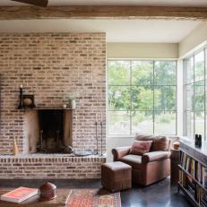 Rustic Living Room Features a Brick Accent Wall With a Built-In Fireplace