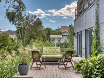 Sustainable Patio With Green Lounge Seating and Natural Landscaping