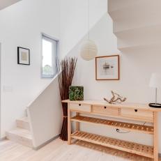 Modern Foyer With White Walls and Light Wood