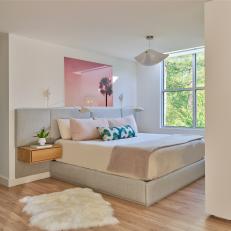 Contemporary White Bedroom With Pink Artwork and Upholstered Headboard