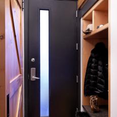 Small Mudroom Accented With Black and Natural Wood Tones