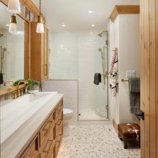 War-Toned Bathroom With Spacious Sink and Wood and Gold Accents