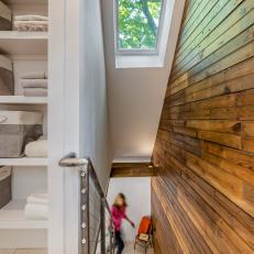 Staircase With Skylight and Tongue and Groove Accent Wall